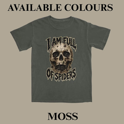 A dark moss green graphic t-shirt featuring a distressed skull design with the text 'I AM FULL OF SPIDERS' in a stylized font. The image is presented as an available color option on a solid beige background with text overlays reading 'AVAILABLE COLOURS' at the top and 'MOSS' at the bottom.