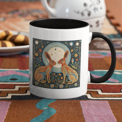 elegant ceramic mug featuring two intricately designed hares under a celestial moon, surrounded by floral patterns and cosmic symbols