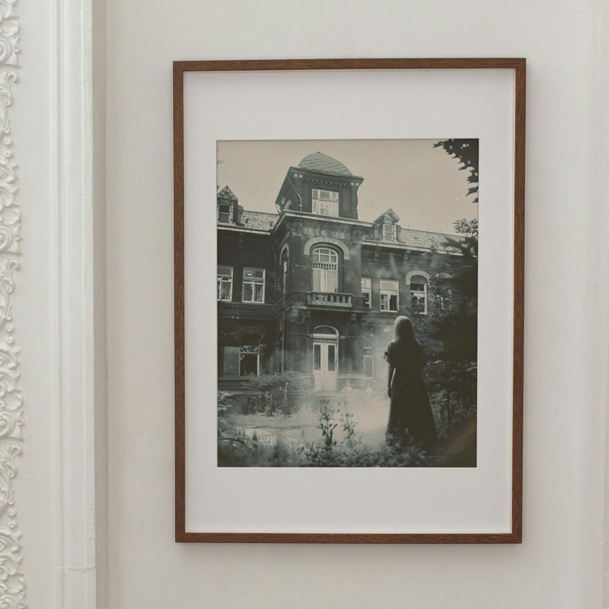 A spooky vintage photo of a mysterious person outside an old, possibly haunted, psychiatric hospital.