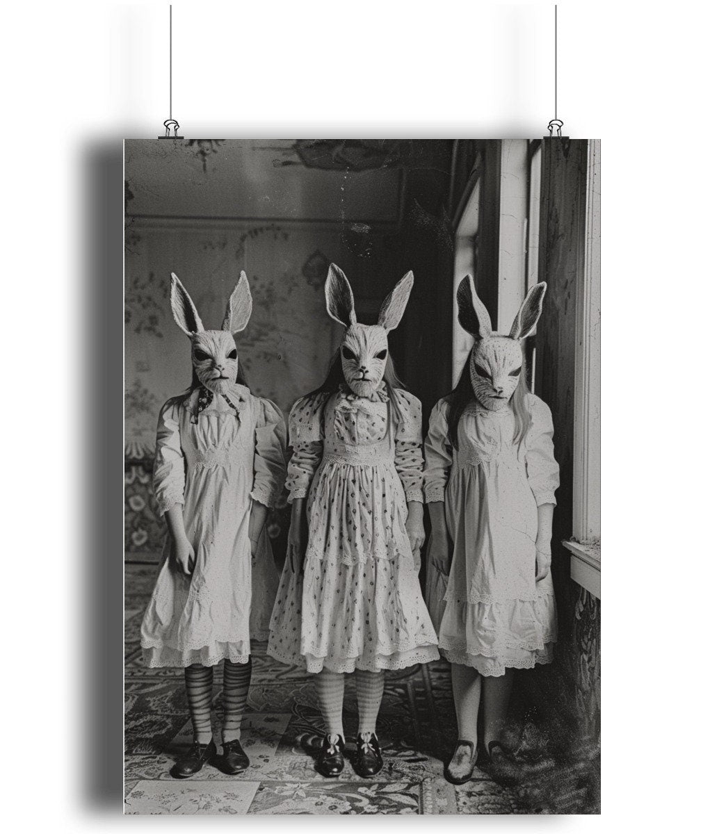 Mysterious black and white print of three girls in Victorian-era clothing and rabbit masks, evoking a dark and surreal atmosphere.