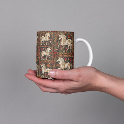Medieval illuminated manuscript images on a Unicorn mug featuring medieval marginalia-inspired art with vibrant floral details.