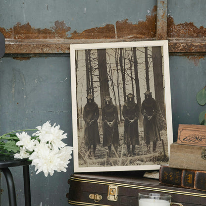 Mysterious image of a forest cult, featuring four masked and robed figures in a sepia, vintage-style photograph.
