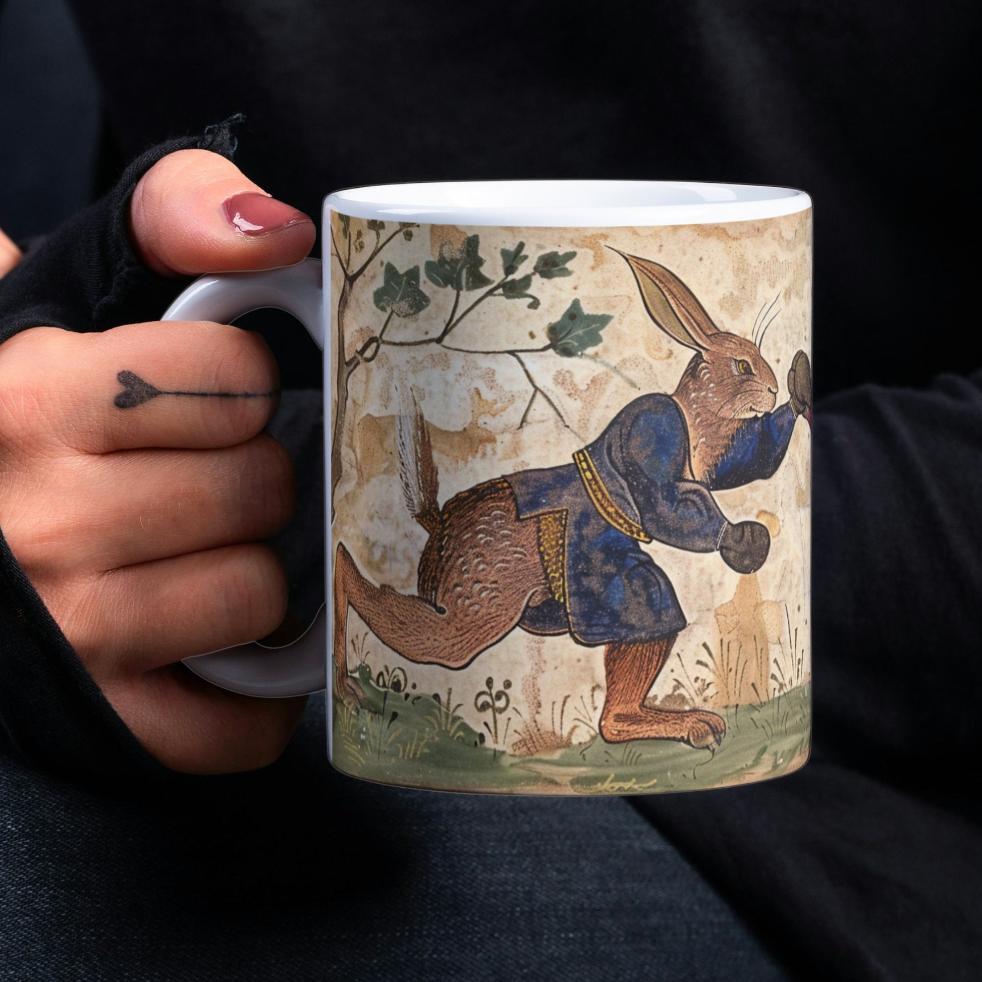 A stunning mug featuring a full-wrap design of mad March hares in a boxing match, inspired by C9th illuminated manuscripts. The hares, wearing boxing gloves, evoke medieval art style, making it a perfect gift for folklore and art lovers.