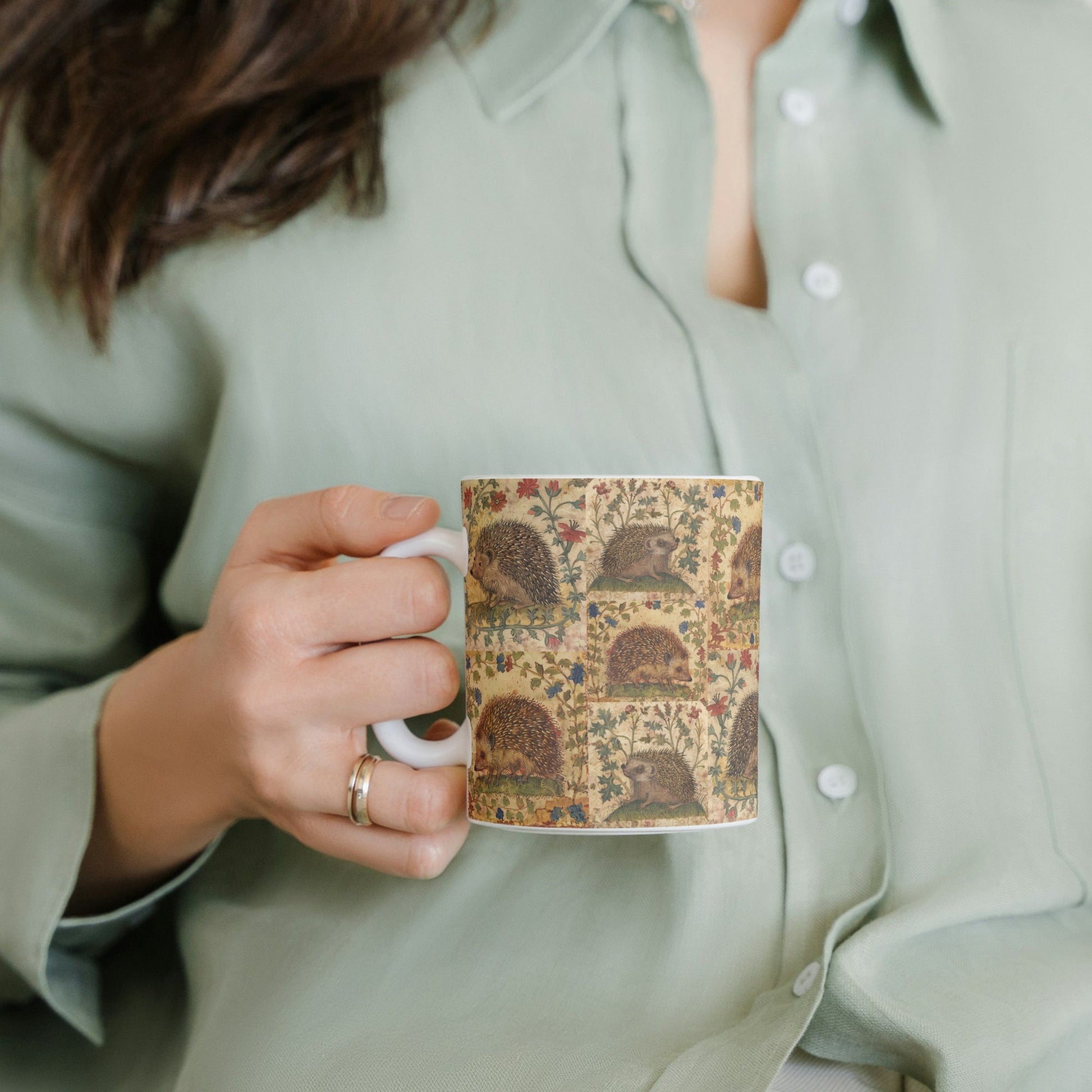 White mug wrapped in a medieval-inspired hedgehog and botanical print