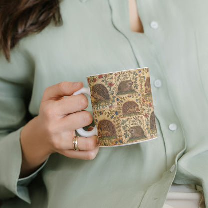 Charming medieval-style mug featuring hedgehogs amidst intricate botanical patterns