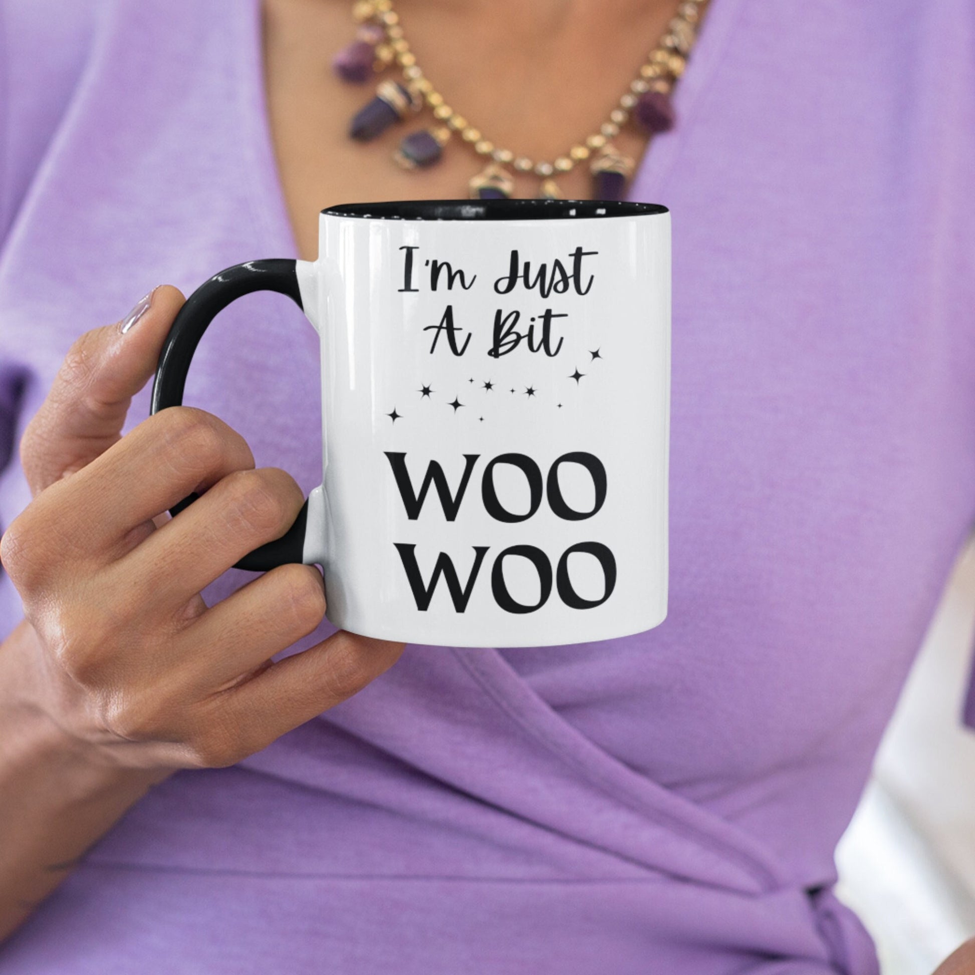 Two toned black and white 11oz ceramic mug with the wording I&#39;m just a bit woo woo, There are a few simple stars to add to the asthetics. A great witchy gift.