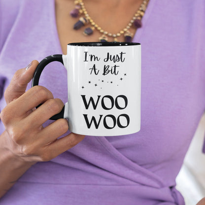 Two toned black and white 11oz ceramic mug with the wording I&#39;m just a bit woo woo, There are a few simple stars to add to the asthetics. A great witchy gift.