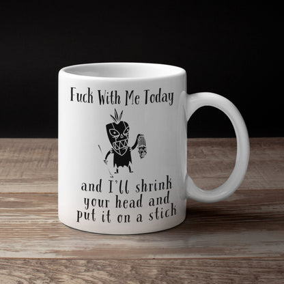 Funny voodoo themed office mug with slogan: Fuck with me today and I&#39;ll shrink your head and put it on a stick. With image of witchdoctor and shrunken head.