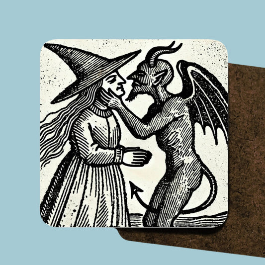 Set of 4 hardwood coasters depicting a witch kissing the Devil in the style of an old woodcut. Great witchy gift. $ x identical cork back drinks mats / coasters. Dark academia.