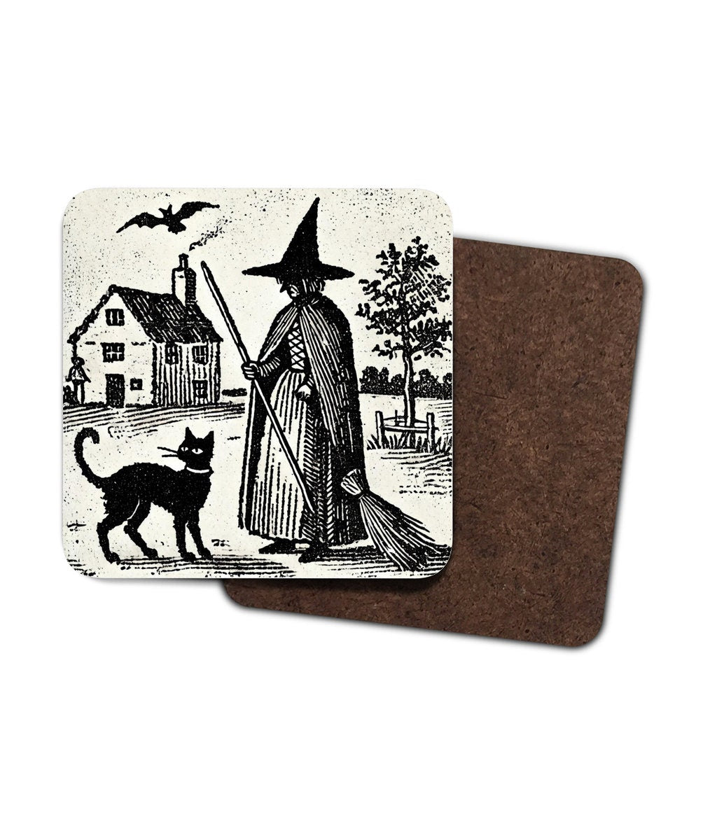 witchy gifts: woodcut of a witch with her familiar, a black cat printed on a cork backed, hardwood coaster. Witches house, home in the background with black cat wearing a collar.