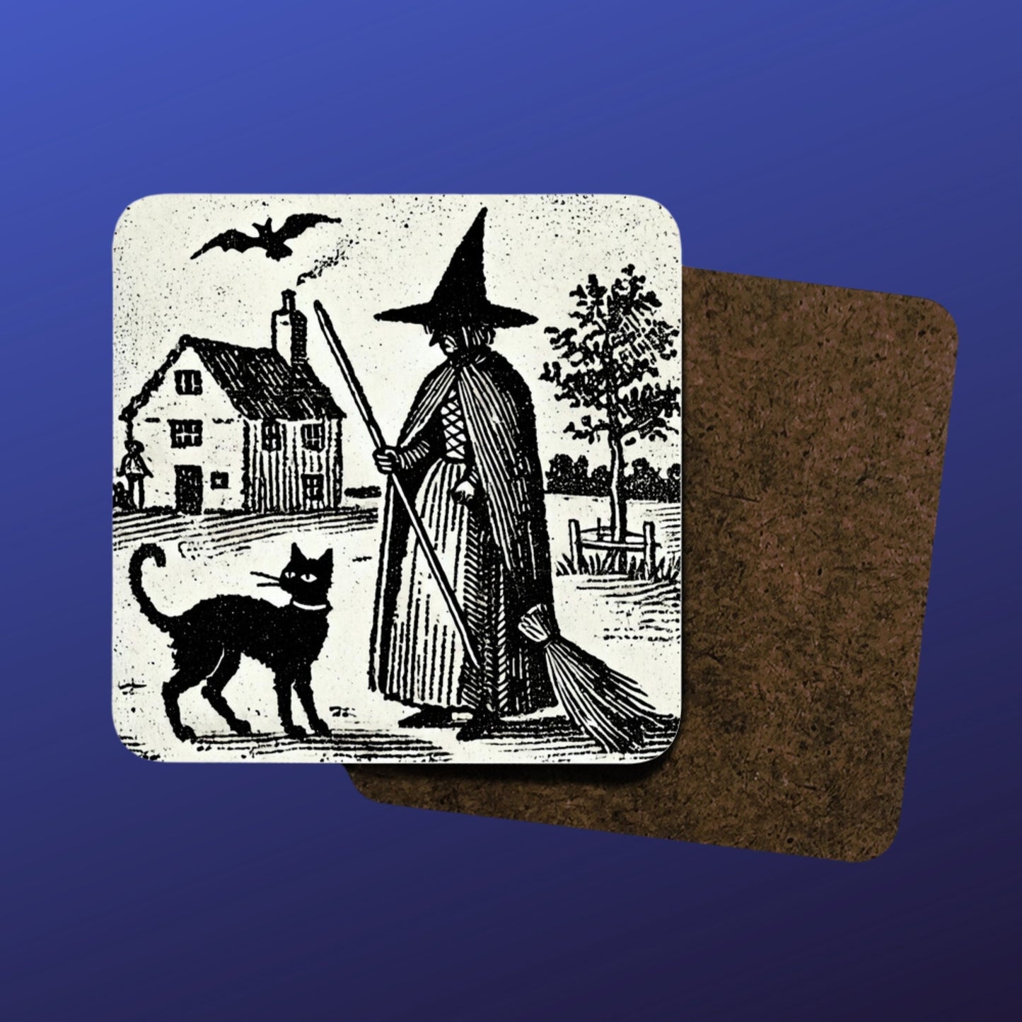 witchy gifts: woodcut of a witch with her familiar, a black cat printed on a cork backed, hardwood coaster. Witches house, home in the background with black cat wearing a collar.