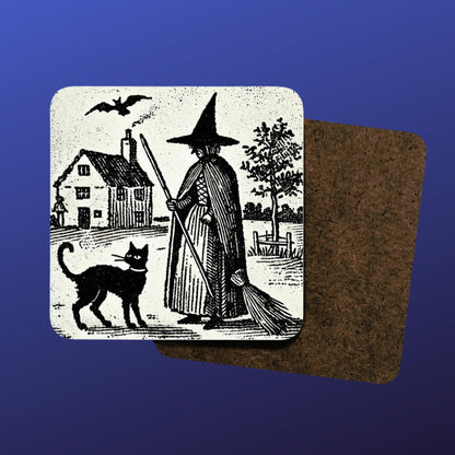 witchy gifts: woodcut of a witch with her familiar, a black cat printed on a cork backed, hardwood coaster. Witches house, home in the background with black cat wearing a collar.