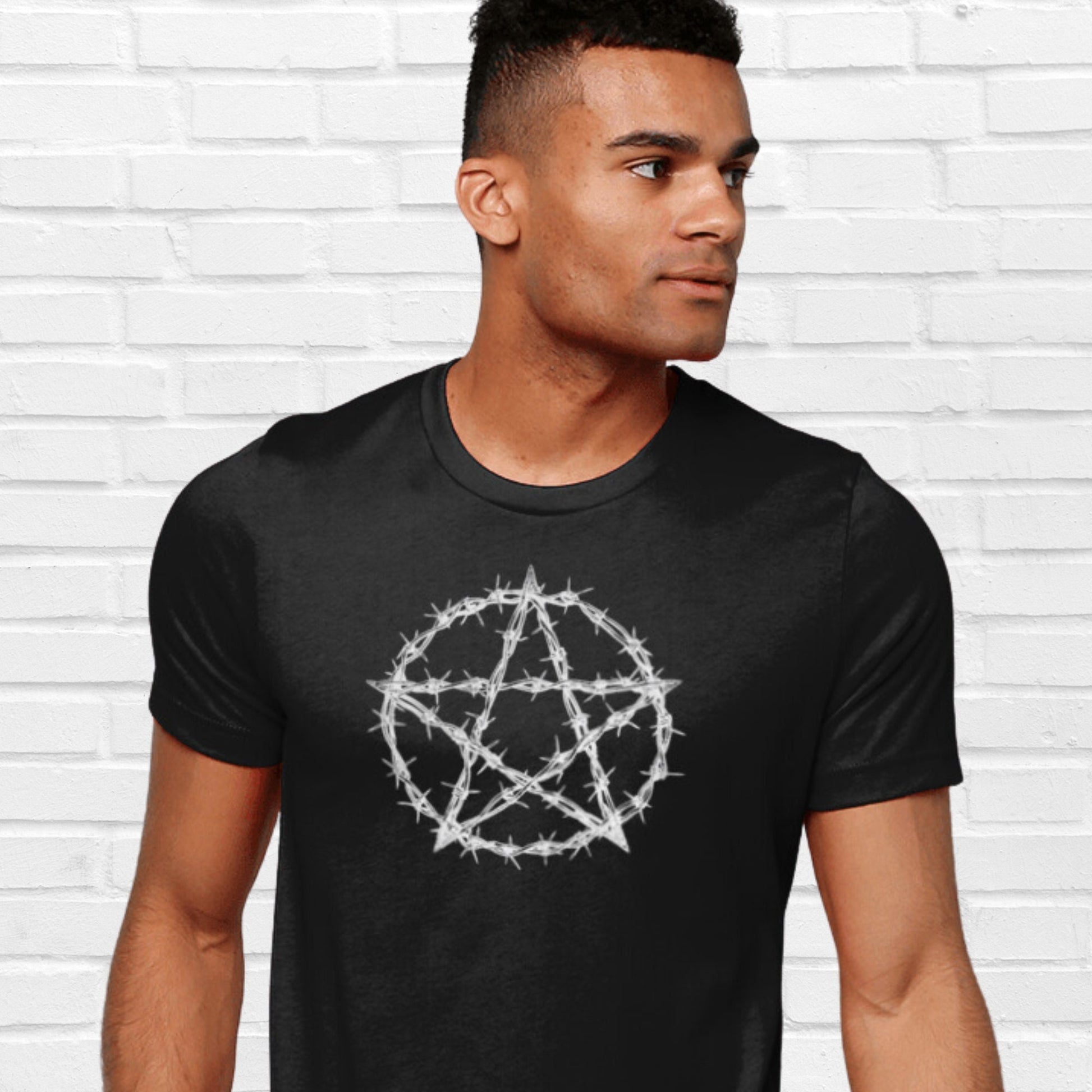 Black unisex cotton tshirt  with a central large pentacle The Pentacle gives the appearance to be covered with barbed wire giving a three-dimensional effect. 
Great gift idea for the witchy person or alternative clothing for a Goth.