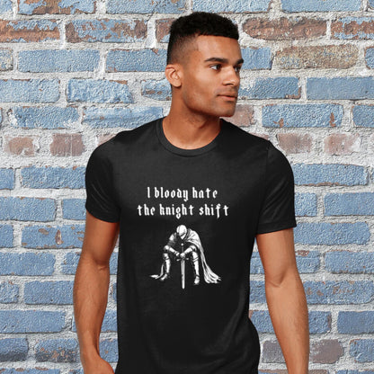 Black t-shirt with detailed illustration of a fed-up medieval knight with the humorous text &#39;I bloody hate the knight shift.&#39; Perfect for night shift workers, medieval history fans, and those with a gothic sense of humour. Marginalia Gift, Gothic Tee