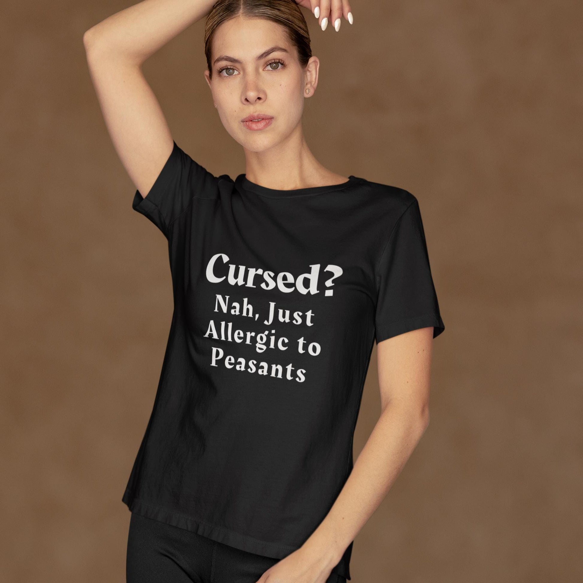 Medieval-inspired black t-shirt with white print, featuring the slogan &#39;Cursed? Nah, Just Allergic to Peasants&#39; in gothic lettering. Perfect for fans of dark humour and historical style. Goth clothing. History teacher gift. Black gothic t-shirt