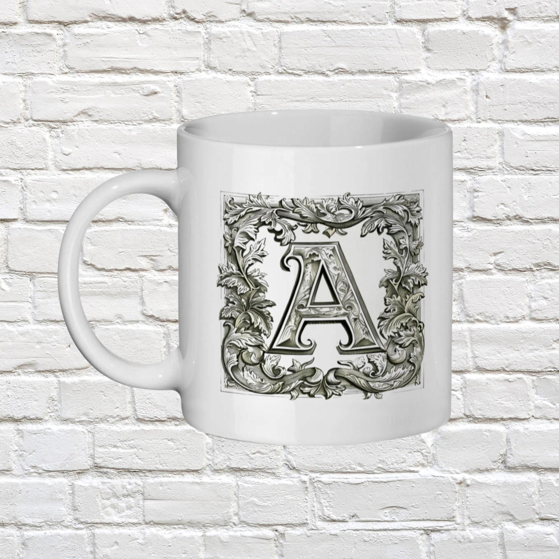 Initial name mug. An artistic mug that presents an initial letter of your choice in an ornate, manuscript-like style, reminiscent of antique book designs
