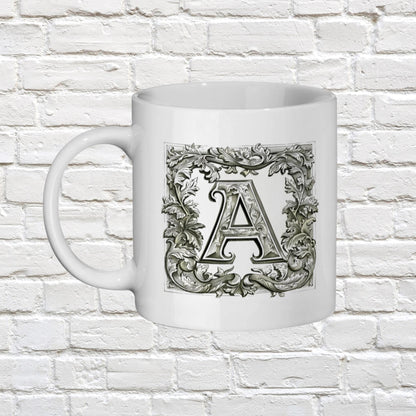 Initial name mug. An artistic mug that presents an initial letter of your choice in an ornate, manuscript-like style, reminiscent of antique book designs
