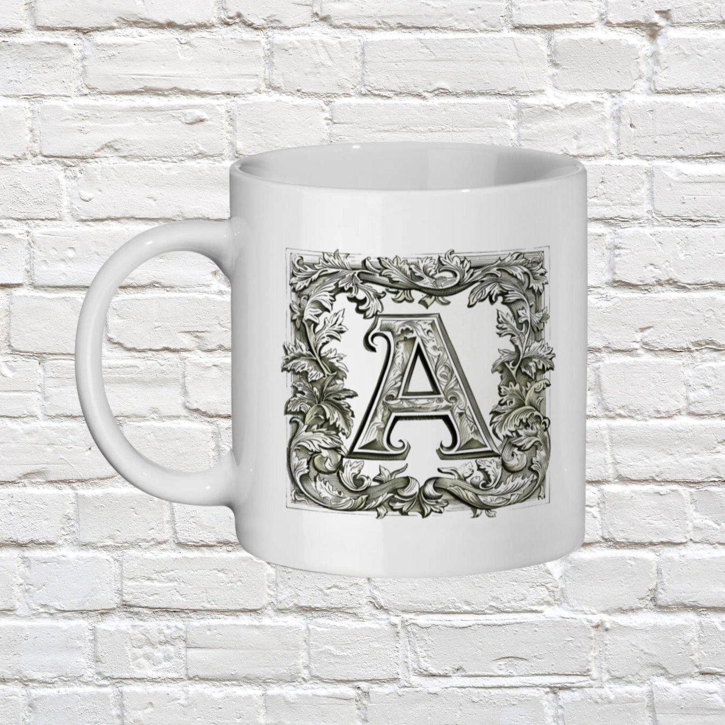 white 11oz ceramic mug with your chosen Personalised Alphabet letter. The black and white letters are in a Medieval illuminated manuscript style font surrounded by a thick border of scrolled leaves