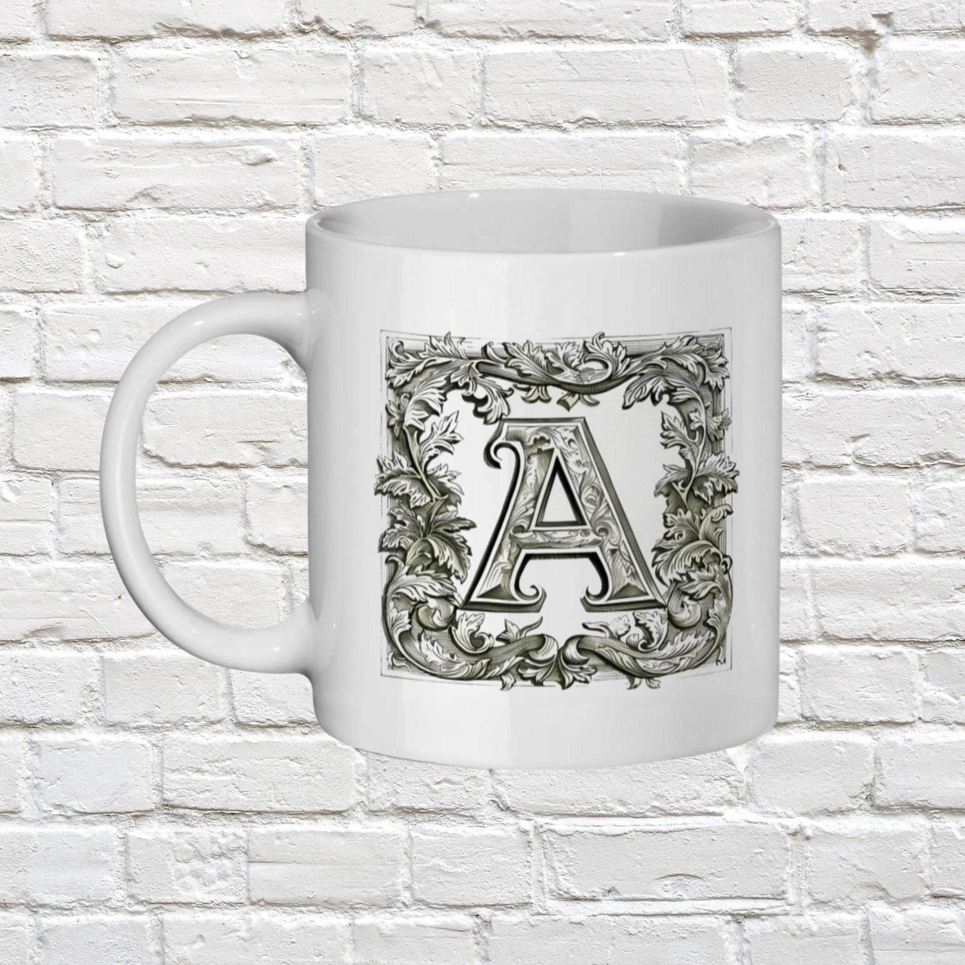 white 11oz ceramic mug with your chosen Personalised Alphabet letter. The black and white letters are in a Medieval illuminated manuscript style font surrounded by a thick border of scrolled leaves