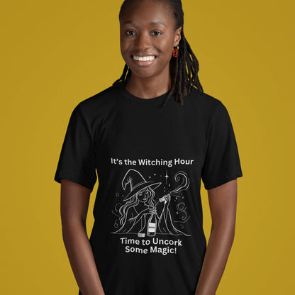 Unisex black t-shirt featuring a witch uncorking a bottle of wine, perfect for wine enthusiasts and Halloween lovers alike