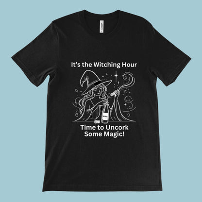 Black unisex t-shirt featuring a witch opening a bottle of wine with the slogan &quot;It&#39;s the witching hour - time to uncork some magic.&quot; Perfect for fans of witchcraft, Wicca, Paganism, or wine lovers.