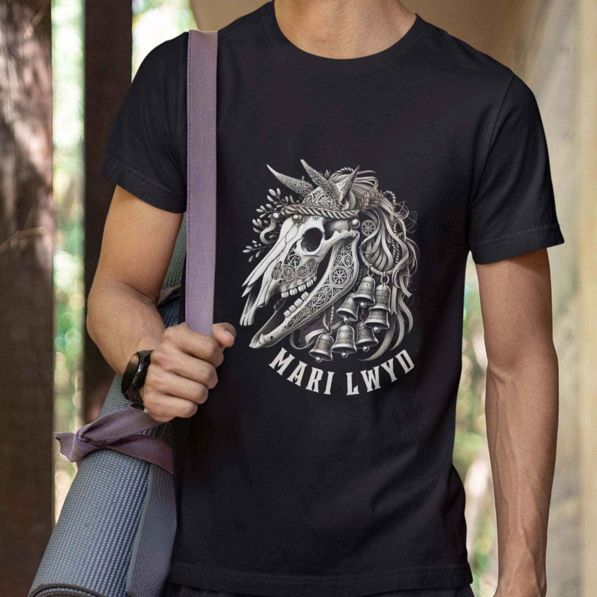ntricate Mari Lwyd horse skull graphic tee adorned with holiday bells and ribbons, rooted in Welsh folklore. Available in black, teal, navy, or forest green, and sizes XS to 2XL