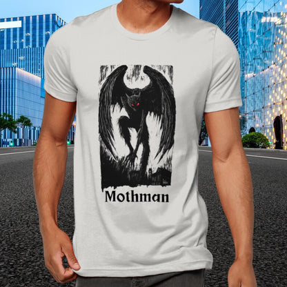 Mothman t-shirt with graphic with dark wings and red eyes on a black background, towering over buildings