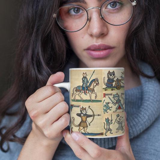 Whimsical ceramic mug featuring medieval marginalia art of cats dressed as knights in armour. Perfect for cat lovers and history enthusiasts who enjoy unique and quirky gifts