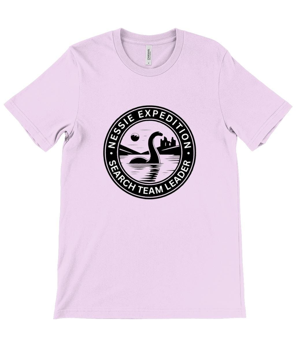 Search Team Leader Graphic Tee - A stylish graphic tee featuring the text &quot;Nessie Expedition Search Team Leader&quot; encircling an iconic depiction of Nessie in the Loch Ness waters.
