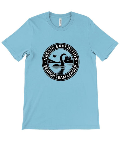 Urquhart Castle and Nessie T-Shirt - A detailed graphic showing the Loch Ness Monster with Scotland&#39;s historic Urquhart Castle in the background, ideal for those who love Scottish myths and history.