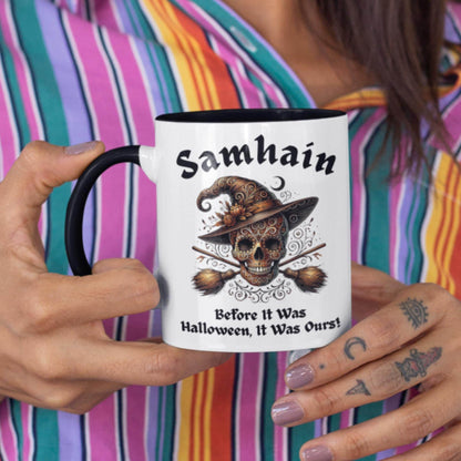 Decorative mug for witches and Wiccans, showcasing a Samhain-themed skull and heraldic broomsticks