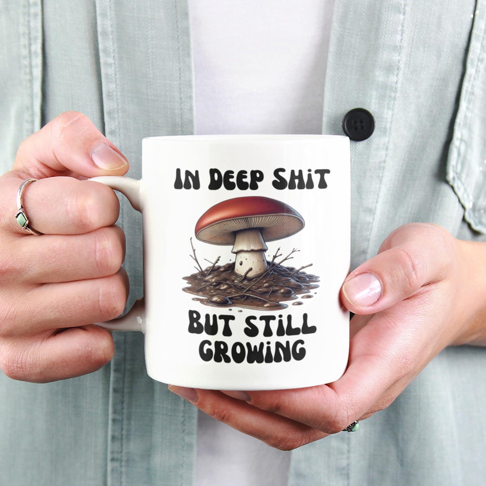 Inspirational coffee mug for mushroom lovers, showcasing a humorous mushroom growing in mud design