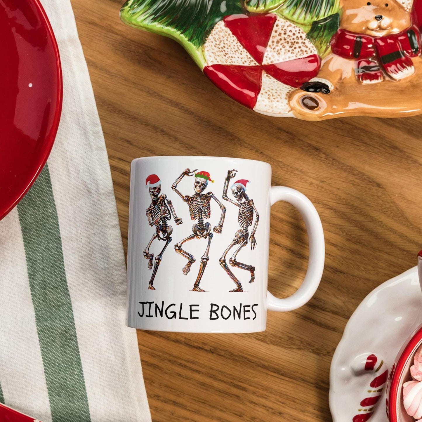 Christmas-themed 11 oz Jingle Bones mug showing skeletons dancing with holiday hats