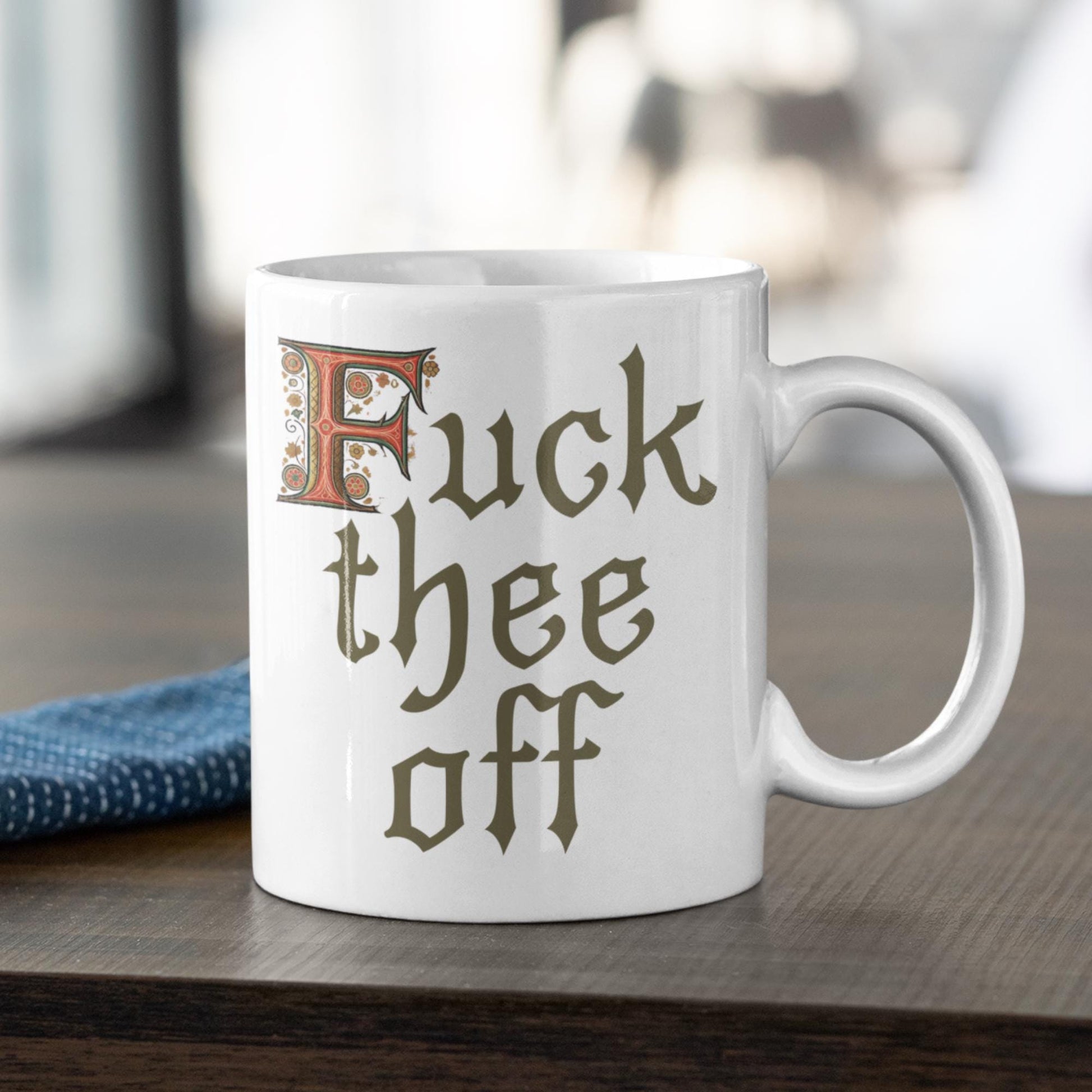 Funny 11oz mug featuring illuminated letter &#39;F&#39; and Gothic text &#39;F*** Thee Off,&#39; designed for sarcastic office humour