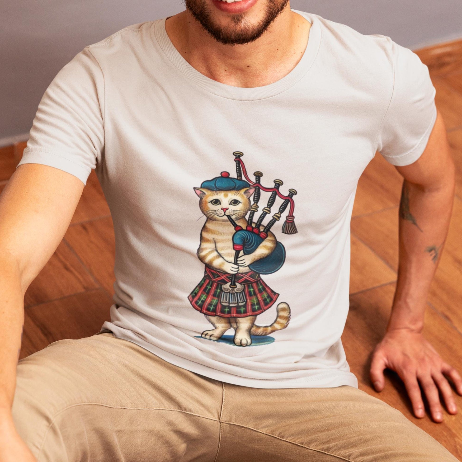 Scottish bagpiper cat wearing a tartan kilt, medieval-inspired artwork on a unisex t-shirt.