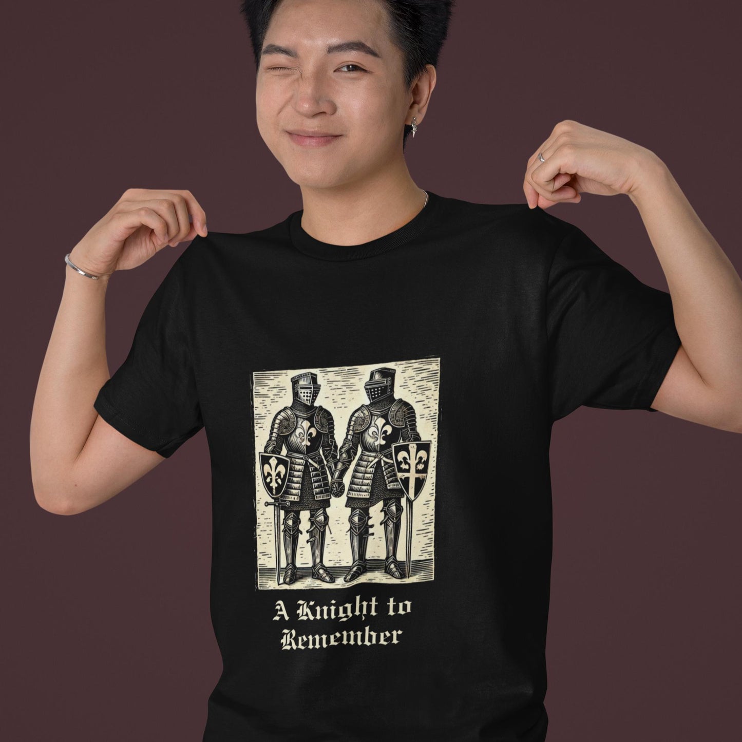 Woodcut-inspired print of two knights in shining armour, embracing their love, featured on a comfortable T-shirt with medieval-style text.